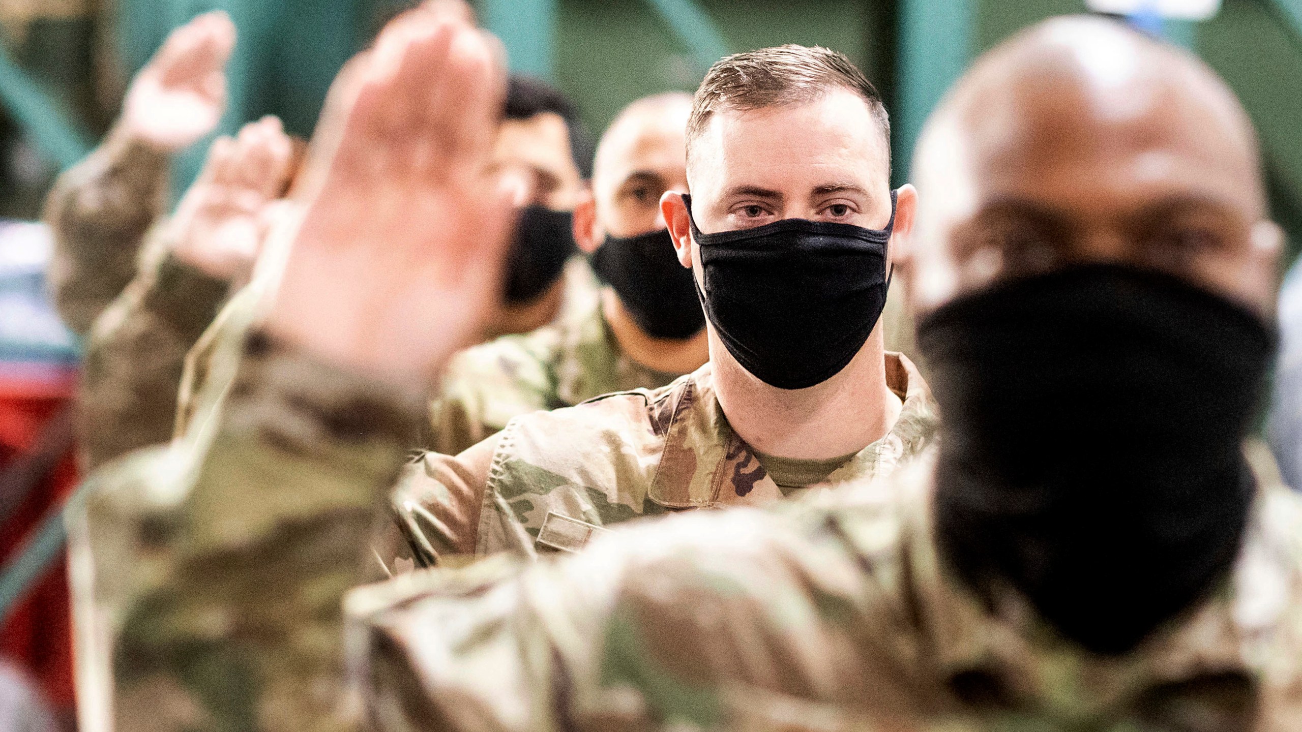 Master Sgt. Jeffery Health takes an oath during a ceremony for U.S. Air Force airmen transitioning to U.S. Space Force guardian designations on Friday, Feb. 12, 2021, at Travis Air Force Base, Calif. (AP Photo/Noah Berger)