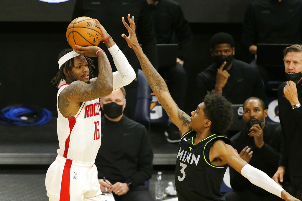 Houston Rockets guard Ben McLemore (16) shoots against Minnesota Timberwolves forward Jaden McDaniels (3) in the fourth quarter during an NBA basketball game, Friday, March 26, 2021, in Minneapolis. (AP Photo/Andy Clayton-King)