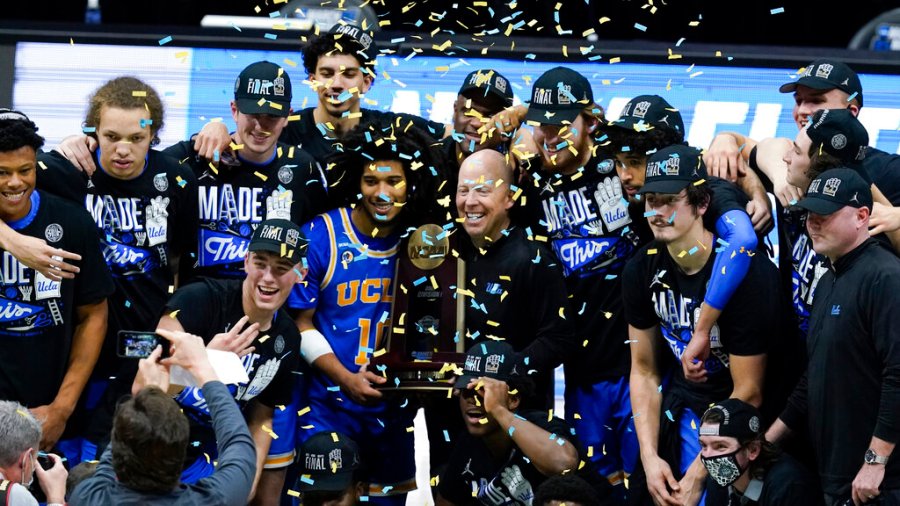 UCLA players and coaches celebrate after an Elite 8 game against Michigan in the NCAA men's college basketball tournament at Lucas Oil Stadium, Wednesday, March 31, 2021, in Indianapolis. UCLA won 51-49. (AP Photo/Darron Cummings)