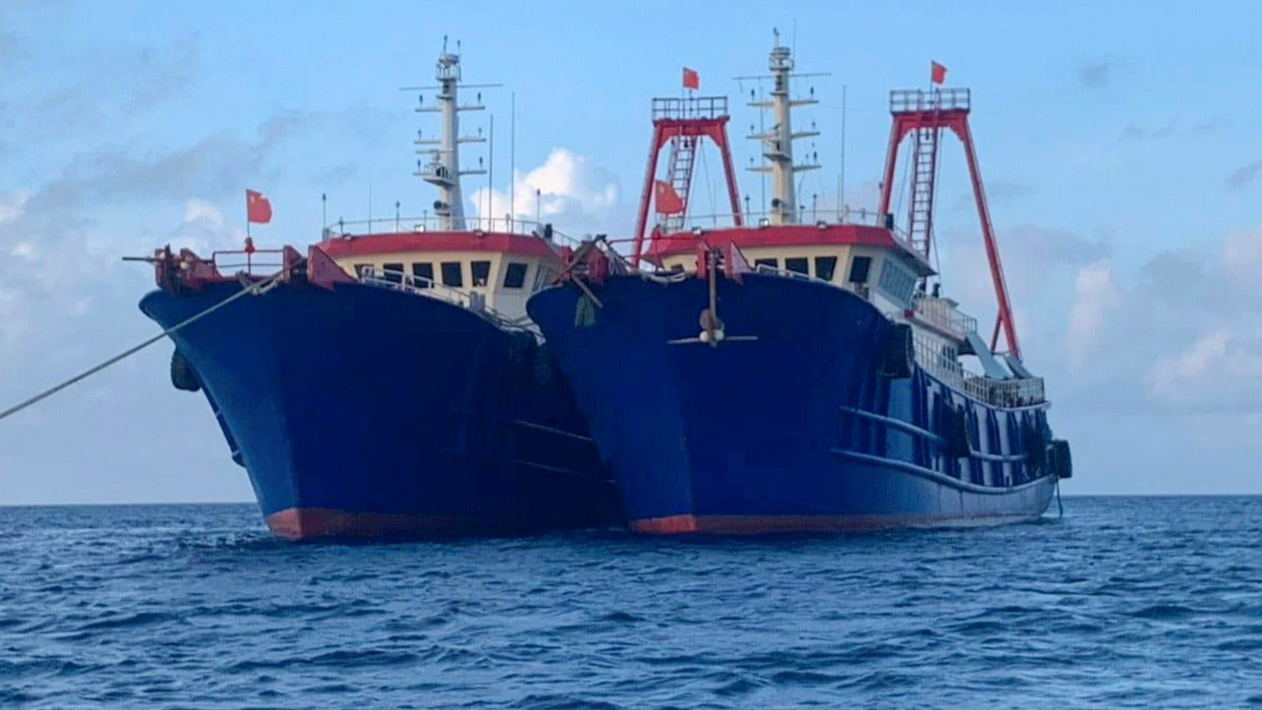 In this photo provided by the National Task Force-West Philippine Sea, Chinese vessels are moored at Whitsun Reef, South China Sea on March 27, 2021. (National Task Force-West Philippine Sea via AP)