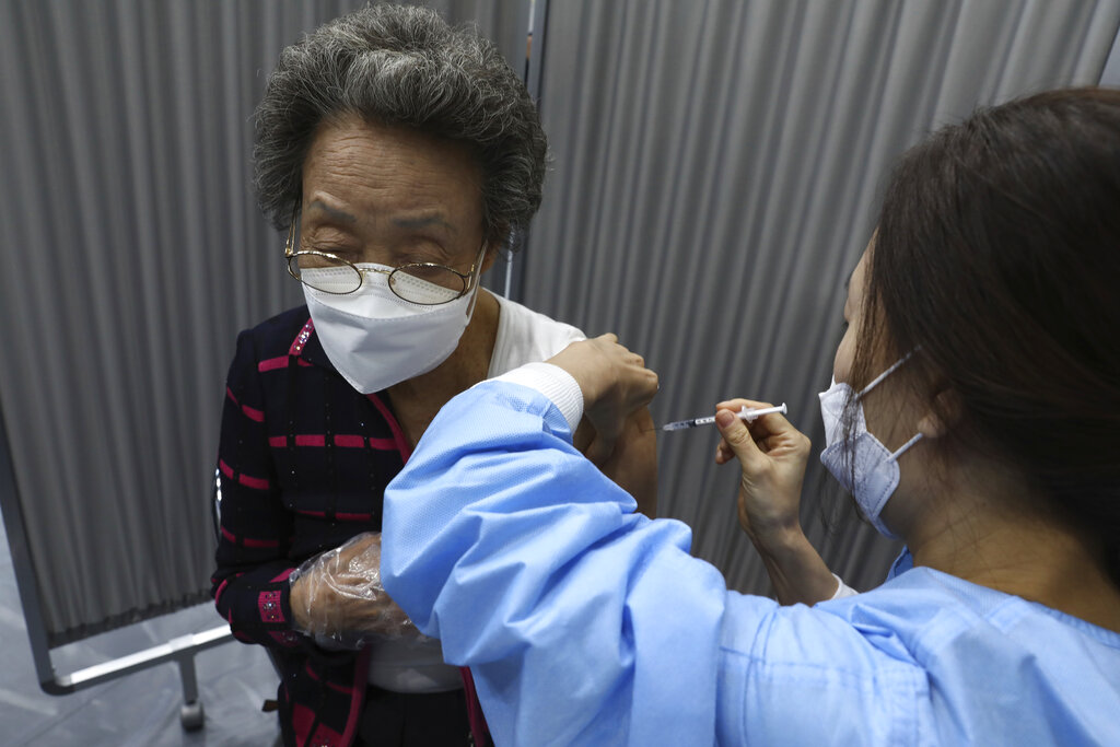 A woman receives the first dose of the Pfizer-BioNTech COVID-19 vaccine at a vaccination center in Seoul, South Korea, Thursday, April 1, 2021. (Chung Sung-Jun/Pool Photo via AP)