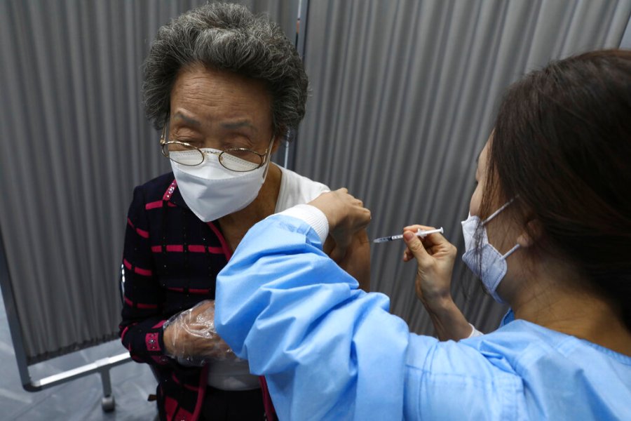 A woman receives the first dose of the Pfizer-BioNTech COVID-19 vaccine at a vaccination center in Seoul, South Korea, Thursday, April 1, 2021. (Chung Sung-Jun/Pool Photo via AP)