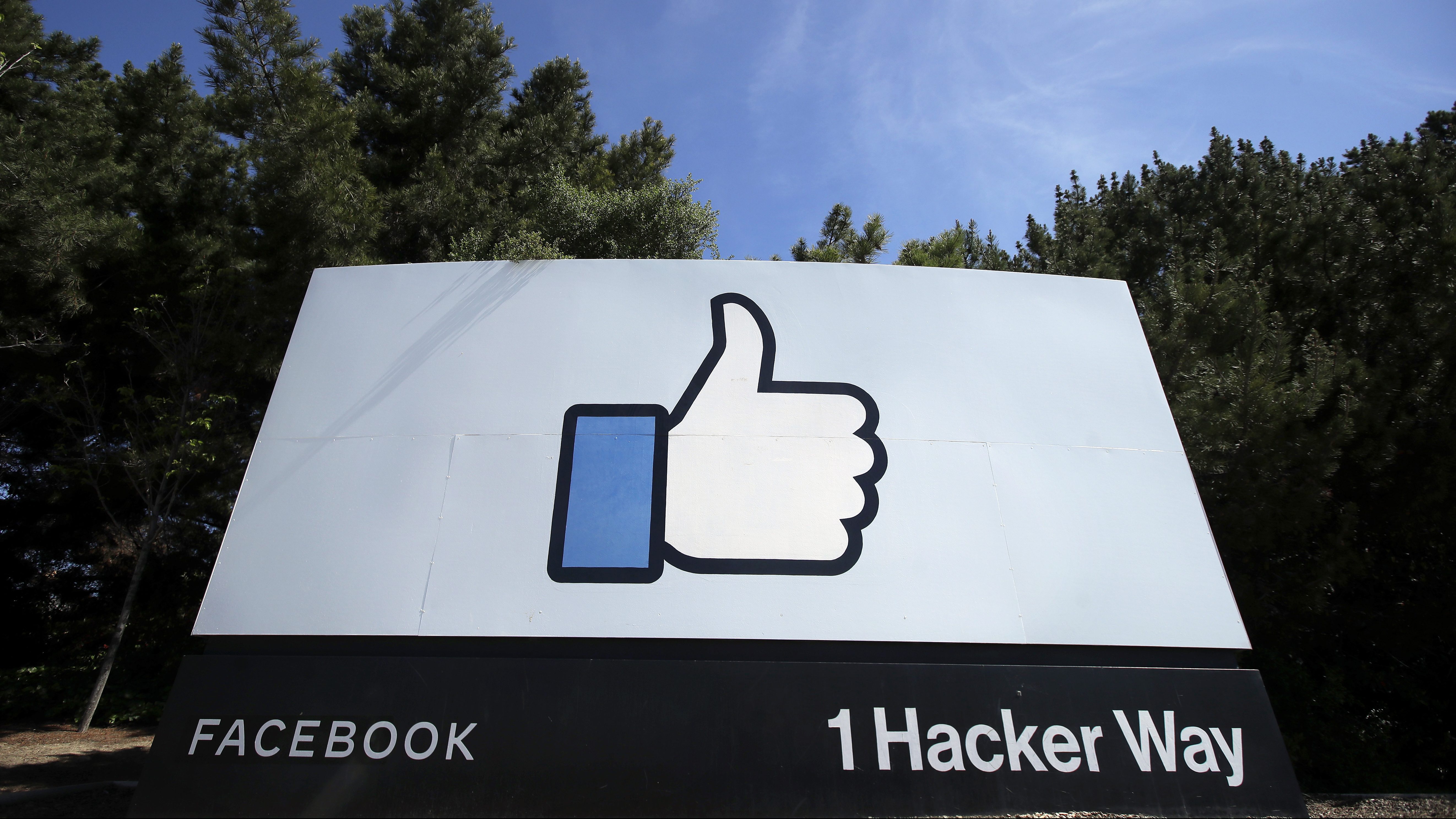 The thumbs up “like” logo is shown on a sign at Facebook headquarters in Menlo Park on April 14, 2020. (Jeff Chiu / Associated Press)