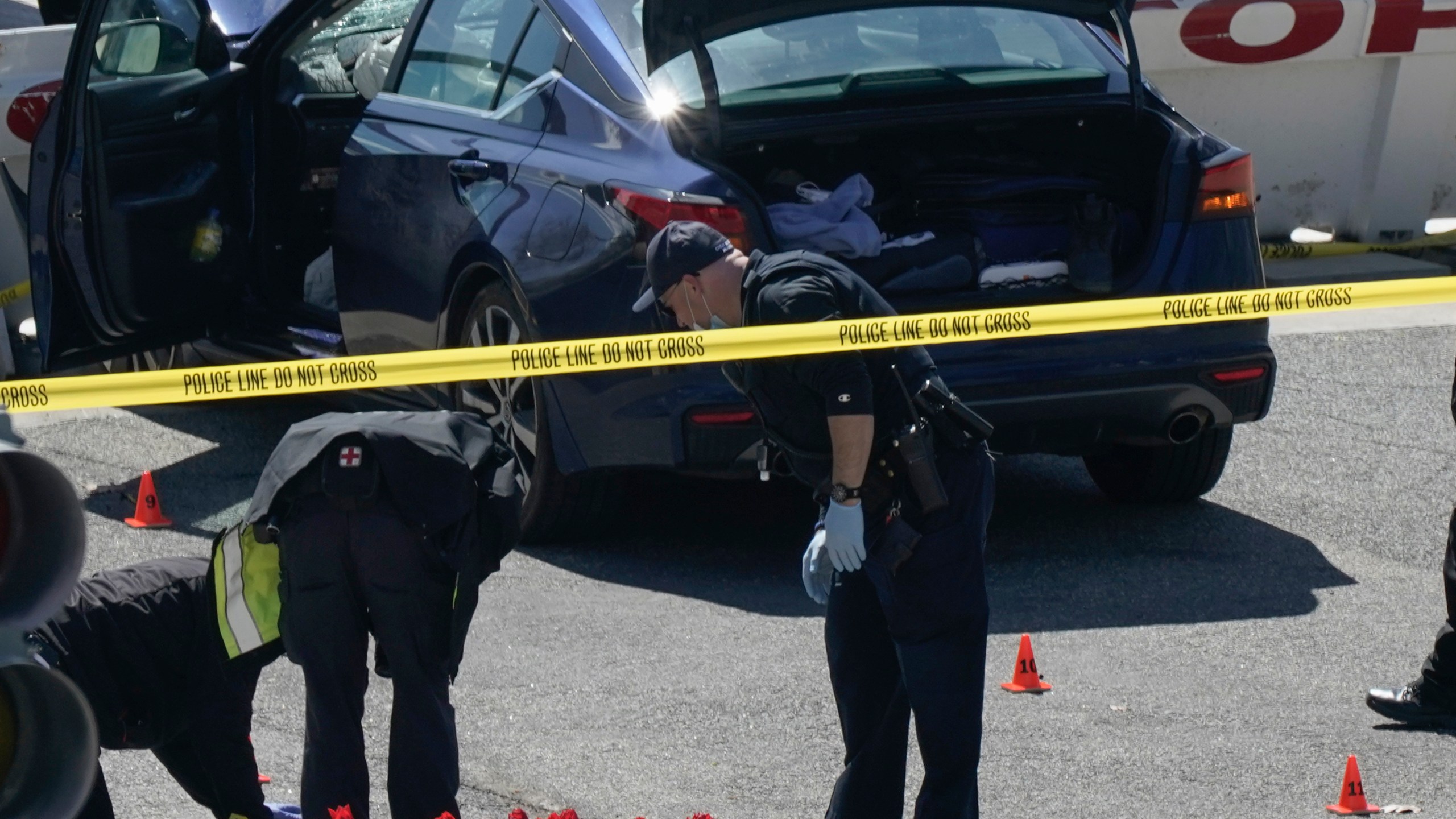 U.S. Capitol Police officers investigate near a car that crashed into a barrier on Capitol Hill near the Senate side fo the U.S. Capitol in Washington, Friday, April 2, 2021. (AP Photo/J. Scott Applewhite)