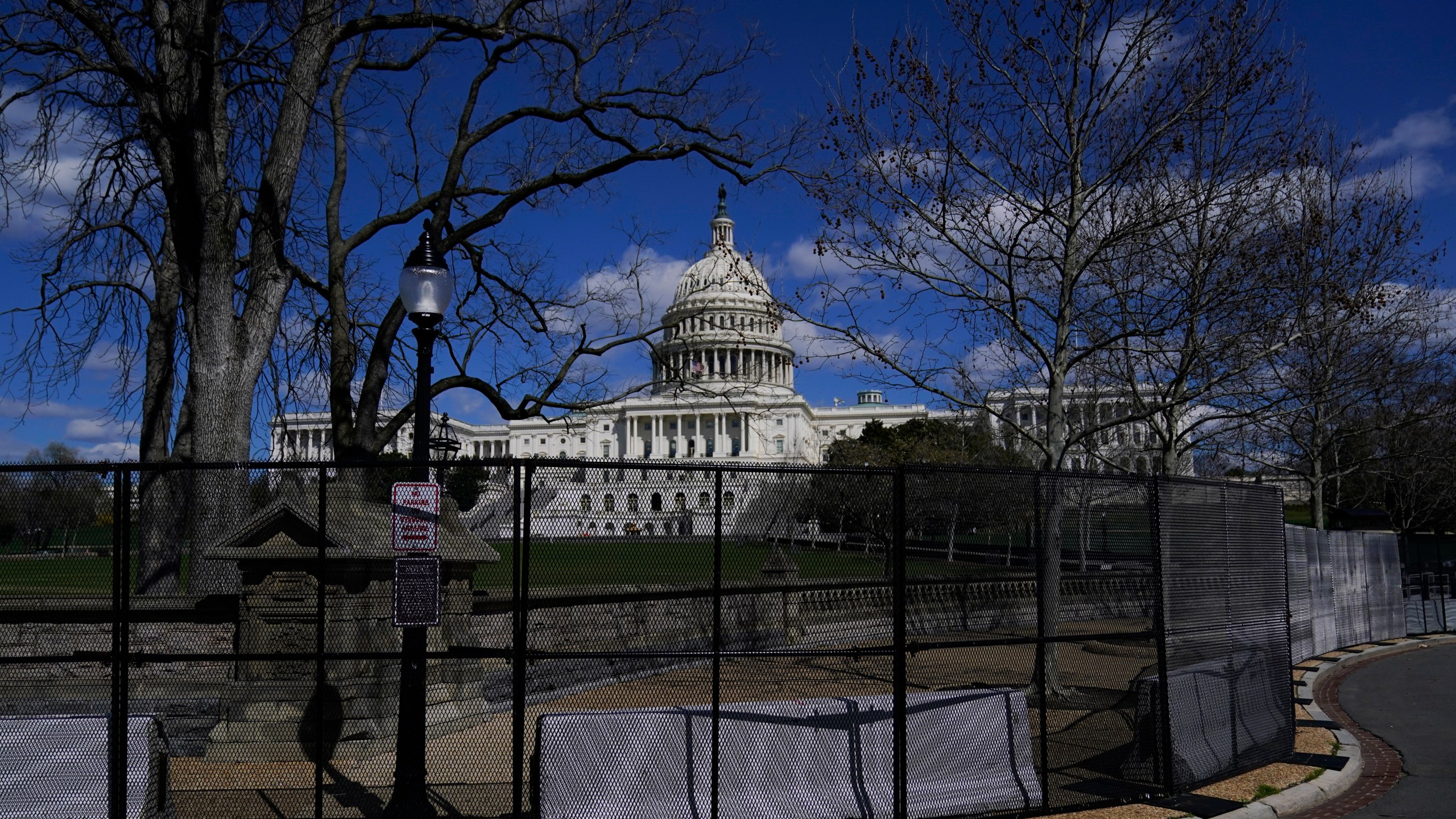 The U.S. Capitol is seen behind security fencing after a car that crashed into a barrier on Capitol Hill in Washington, Friday, April 2, 2021. (AP Photo/Carolyn Kaster)