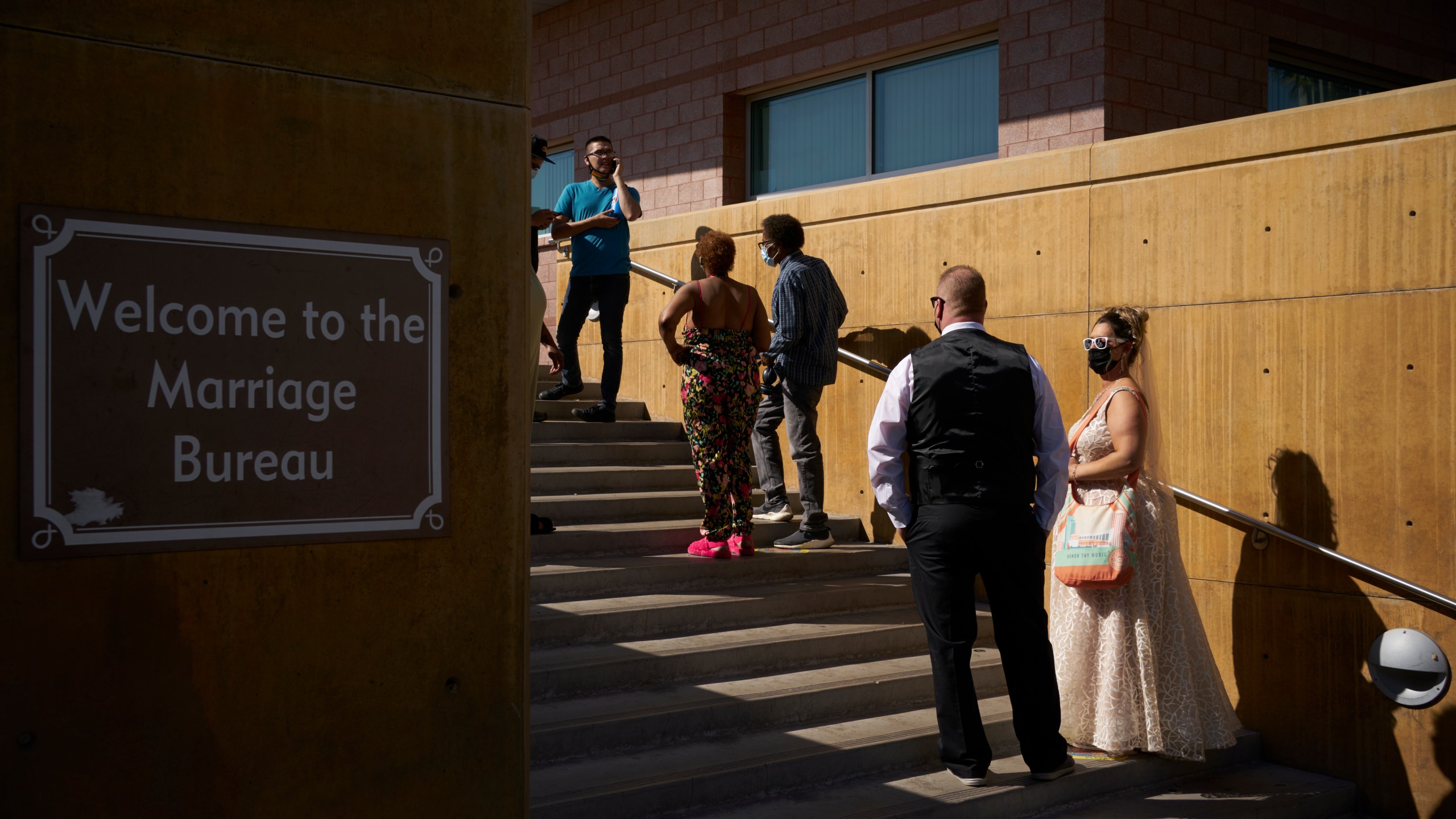 Couples wait in line for marriage licenses at the Marriage License Bureau, Friday, April 2, 2021, in Las Vegas. (AP Photo/John Locher)