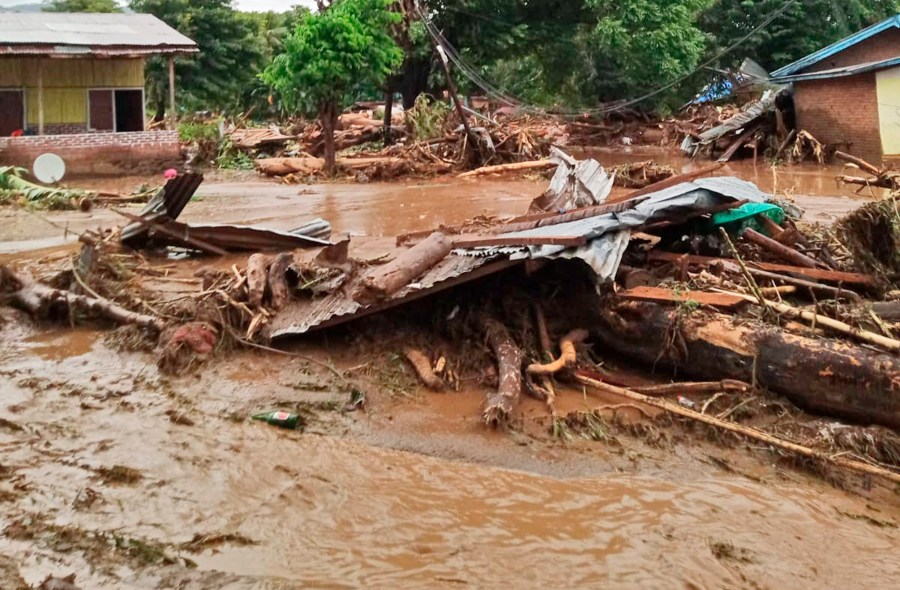 Debris litter an area hit by flash flood in East Flores, Indonesia, Sunday, April 4, 2021. Landslides and flash floods from torrential rains in eastern Indonesia have killed a number of people and displaced thousands, the disaster agency said Sunday. (AP Photo/Ola Adonara)