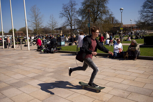 People enjoy a fine spring day in Stratford-upon-Avon, England, Sunday April 4, 2021. (Jacob King/PA via AP)