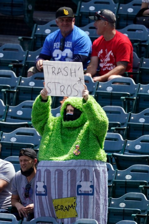 A fan wears an Oscar the Grouch costume as he taunts the Houston Astros prior to a baseball game against the Los Angeles Angels Tuesday, April 6, 2021, in Anaheim, Calif. (AP Photo/Mark J. Terrill)