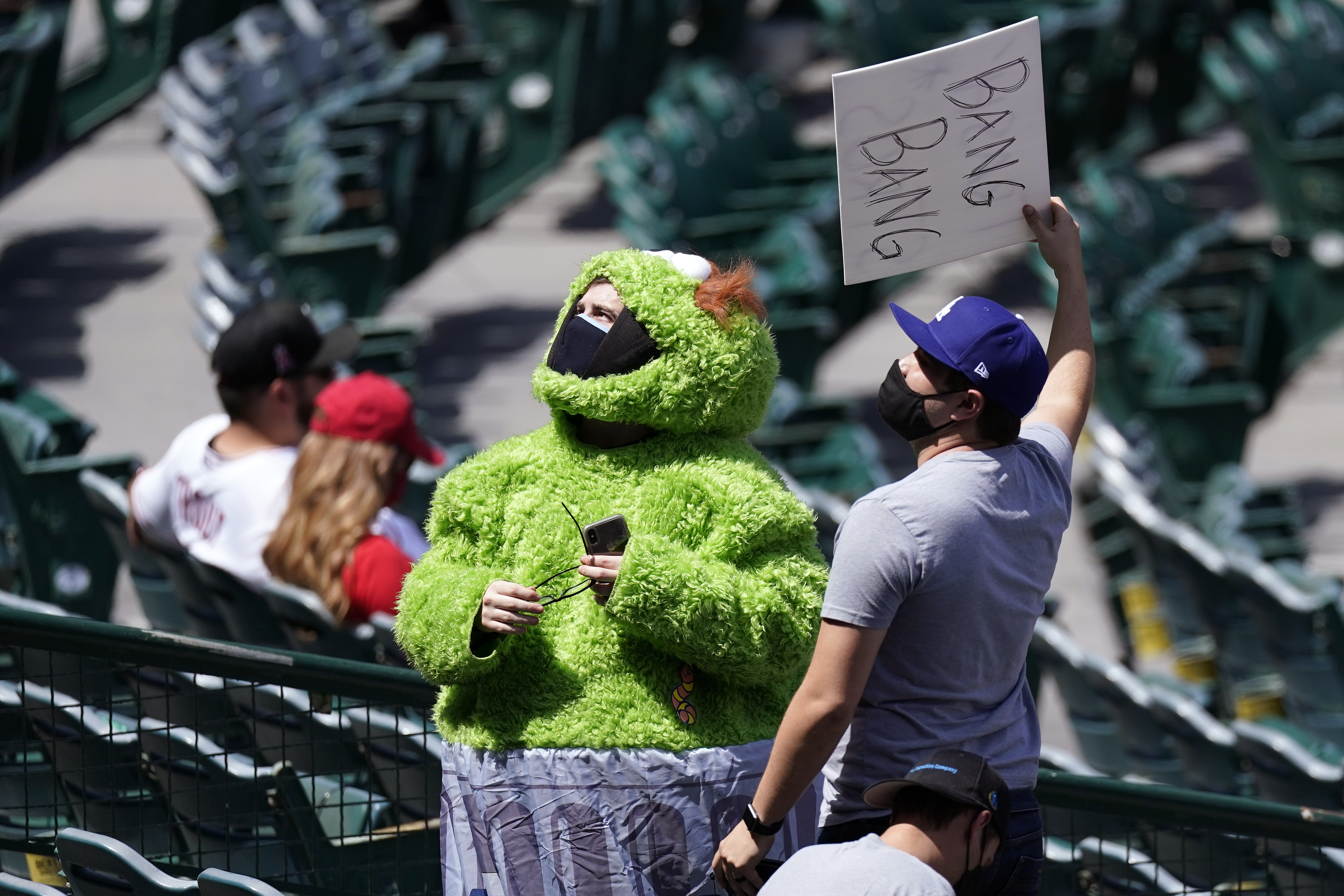 A fan wears an Oscar the Grouch costume as he taunts the Houston Astros prior to a baseball game against the Los Angeles Angels Tuesday, April 6, 2021, in Anaheim, Calif. (AP Photo/Mark J. Terrill)