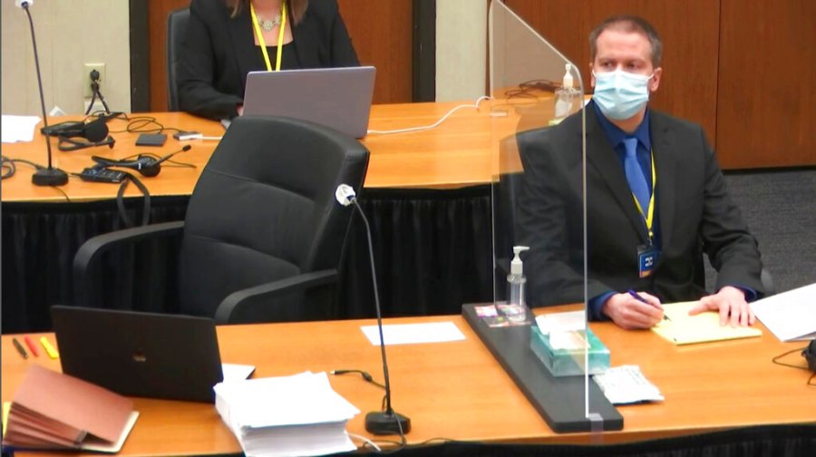 In this image taken from video, former Minneapolis police Officer Derek Chauvin watches as defense attorney Eric Nelson questions witness Los Angeles police department Sergeant Jody Stiger, Wednesday, April 7, 2021, during Chauvin's at the trial at the Hennepin County Courthouse in Minneapolis. (Court TV via AP, Pool)