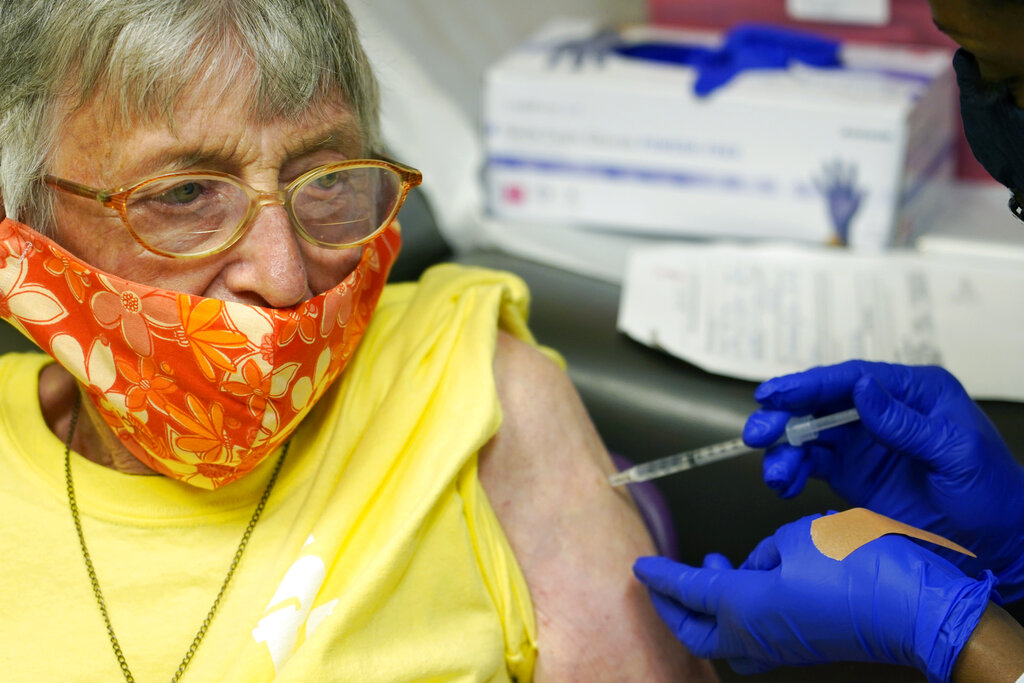 Linda Busby, 74, stiffens up as she receives the Johnson & Johnson COVID-19 vaccine at the Aaron E. Henry Community Health Service Center, Wednesday, April 7, 2021, in Clarksdale, Miss. (AP Photo/Rogelio V. Solis)