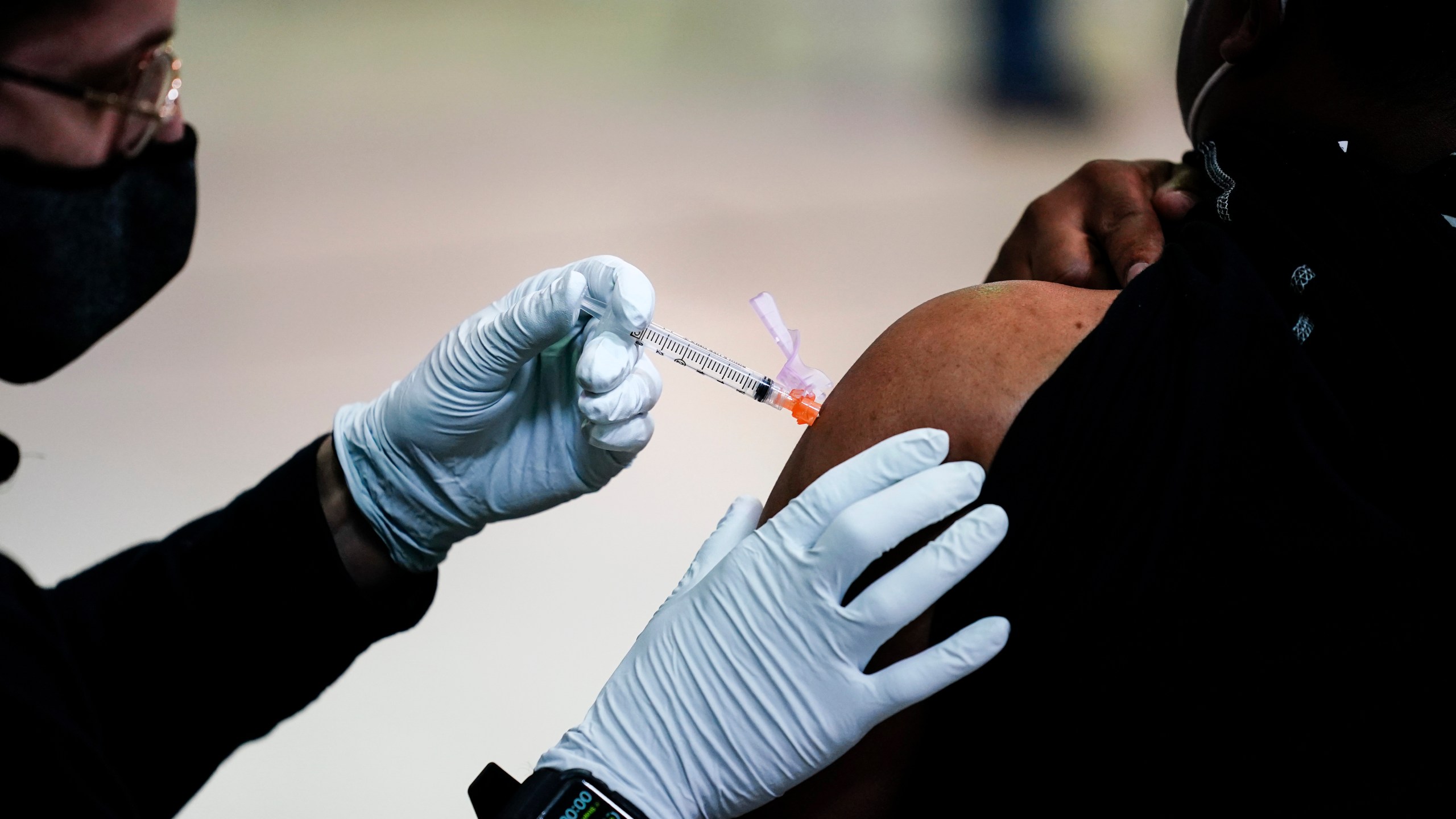 In this March 26, 2021, file photo, a member of the Philadelphia Fire Department administers the Johnson & Johnson COVID-19 vaccine to a person at a vaccination site at a Salvation Army location in Philadelphia. (AP Photo/Matt Rourke, File)