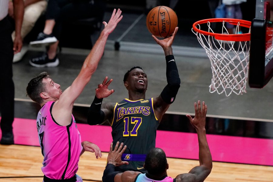 Los Angeles Lakers guard Dennis Schroder (17) drives to the basket as Miami Heat guard Goran Dragic (7) defends, during the first half of an NBA basketball game, Thursday, April 8, 2021, in Miami. (AP Photo/Marta Lavandier)