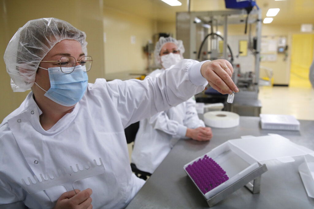 Employees work at the Delpharm plant in Saint-Remy-sur-Avre, west of Paris, Friday, April 9, 2021 in Paris. (AP Photo/Christophe Ena, Pool)