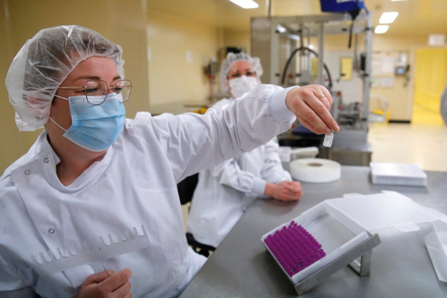 Employees work at the Delpharm plant in Saint-Remy-sur-Avre, west of Paris, Friday, April 9, 2021 in Paris. (AP Photo/Christophe Ena, Pool)