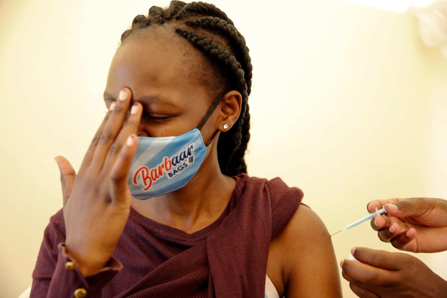 In this April 8, 2021, file photo, a woman at Kenyatta National Hospital in Nairobi, Kenya, receives a dose of AstraZeneca COVID-19 vaccine. (AP Photo/Brian Inganga, File)