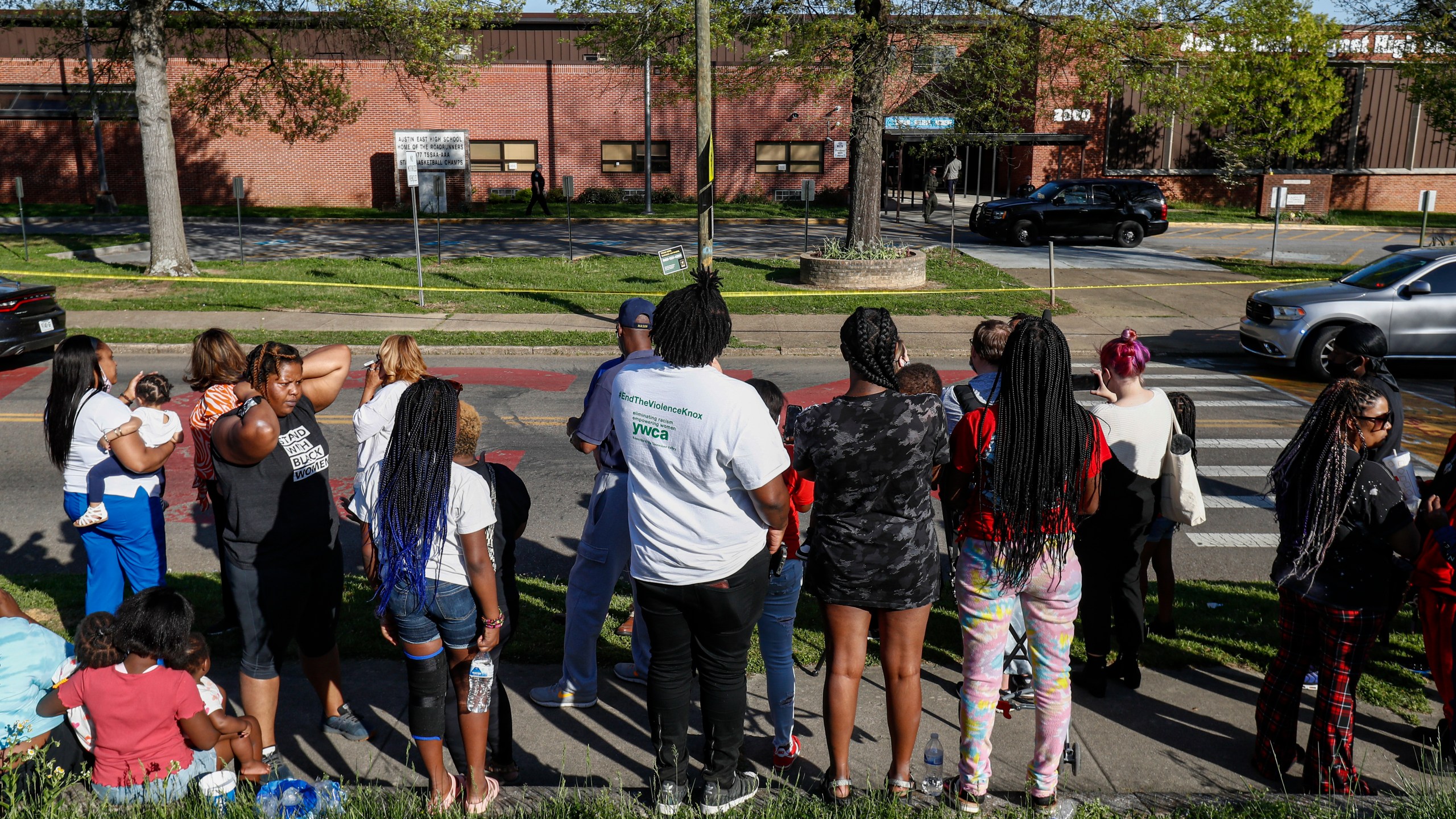 People look on as Knoxville police work the scene of a shooting at Austin-East Magnet High School in Knoxville, Tenn., on April 12, 2021. (Wade Payne / Associated Press)