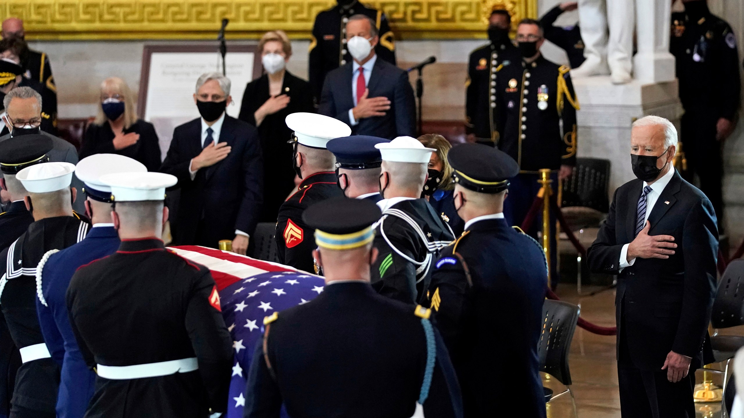 President Joe Biden stands as a joint services honor guard carries the flag-draped casket of U.S. Capitol Police officer William "Billy" Evans, to where he will lie in honor at the Capitol in Washington, Tuesday, April 13, 2021. (Amr Alfiky/The New York Times via AP, Pool)