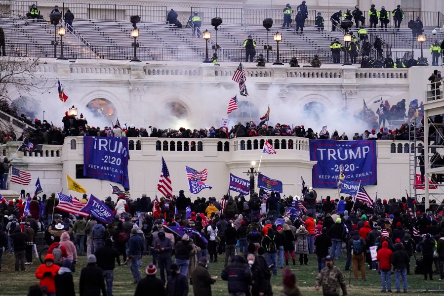 In this Jan. 6. 2021, file photo, people storm the Capitol in Washington. (John Minchillo/Associated Press)