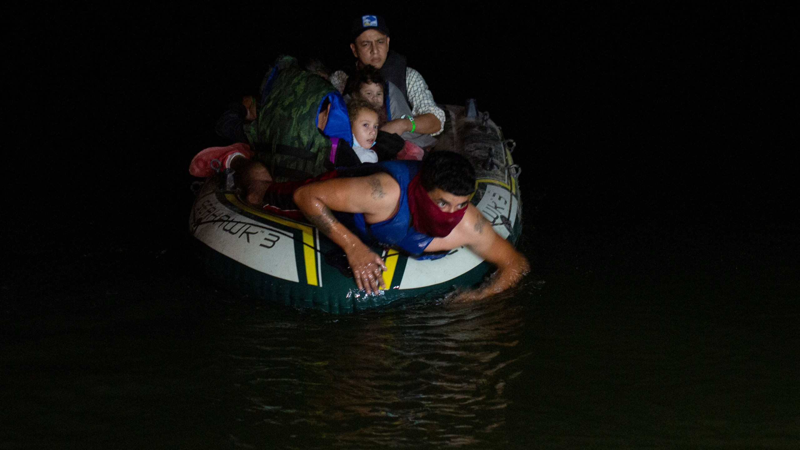 In this March 30, 2021 file photo, a smuggler takes migrants, mostly from Central American countries, on a small inflatable raft towards U.S. soil, in Roma, Texas. (Dario Lopez-Mills, Associated Press)