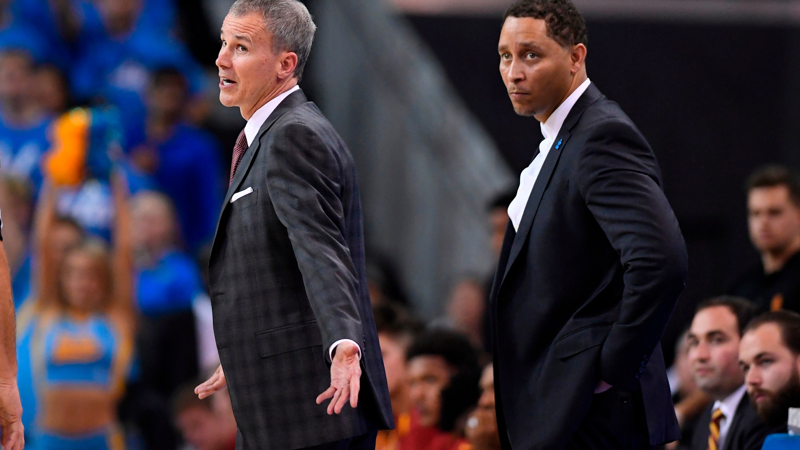 In this Feb. 18, 2017, file photo, Southern California head coach Andy Enfield, left, talks to officials as assistant coach Tony Bland stands behind him during the second half of an NCAA college basketball game against UCLA, in Los Angeles. The NCAA hit Southern California’s men's basketball program with two years’ probation and a $5,000 fine as the result of a former assistant who violated NCAA ethical conduct rules when he accepted a bribe to steer players to a business management company. (AP Photo/Mark J. Terrill, File)