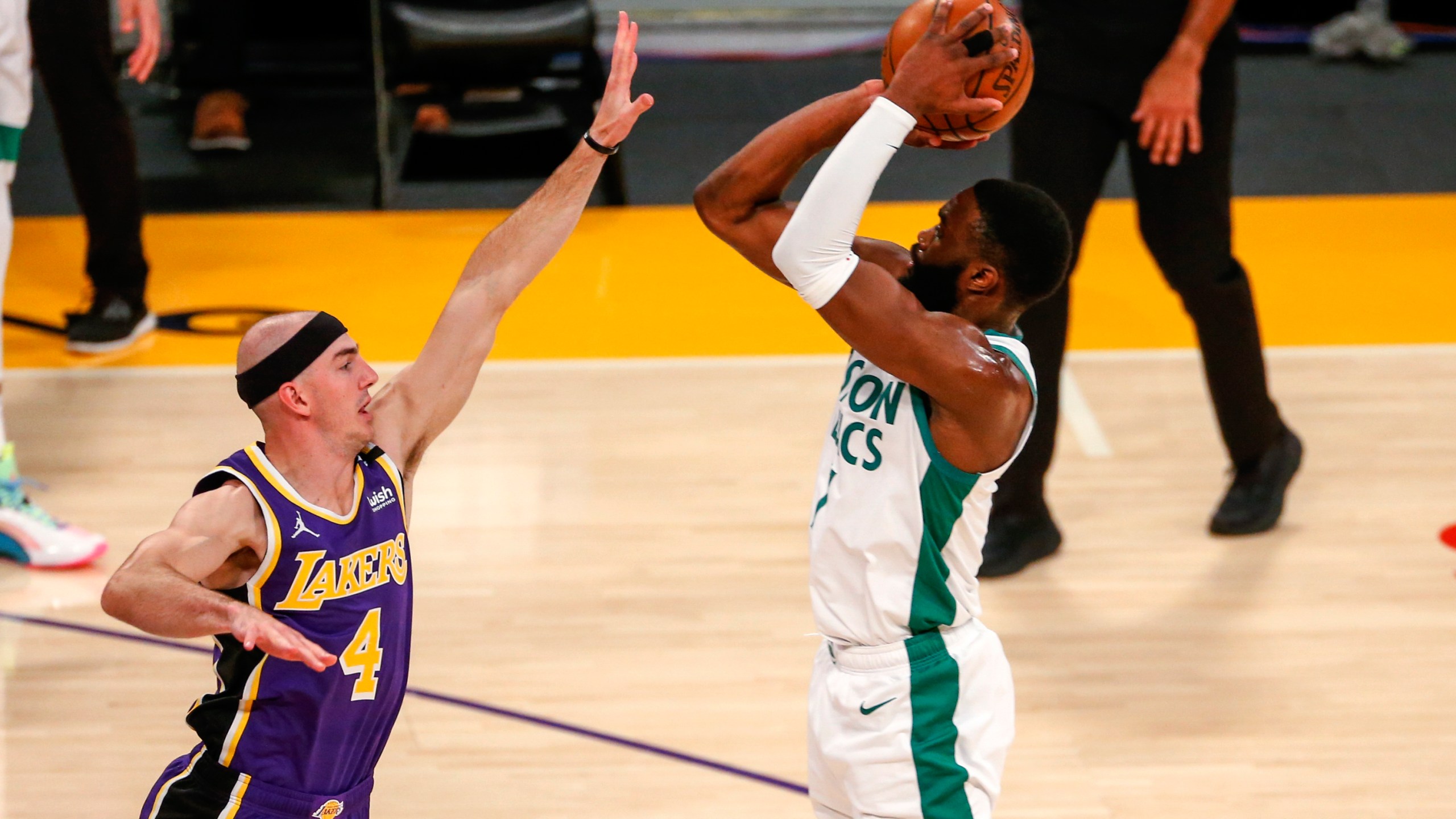 Boston Celtics' Jaylen Brown shoots over Los Angeles Lakers' Alex Caruso (4) during the first half of an NBA basketball game in Los Angeles on April 15, 2021. (Ringo H.W. Chiu / Associated Press)