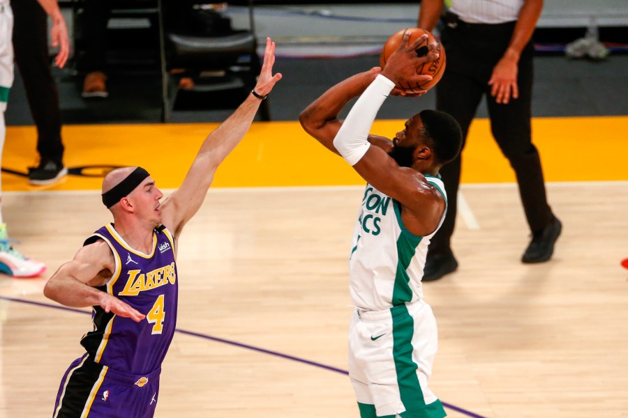 Boston Celtics' Jaylen Brown shoots over Los Angeles Lakers' Alex Caruso (4) during the first half of an NBA basketball game in Los Angeles on April 15, 2021. (Ringo H.W. Chiu / Associated Press)