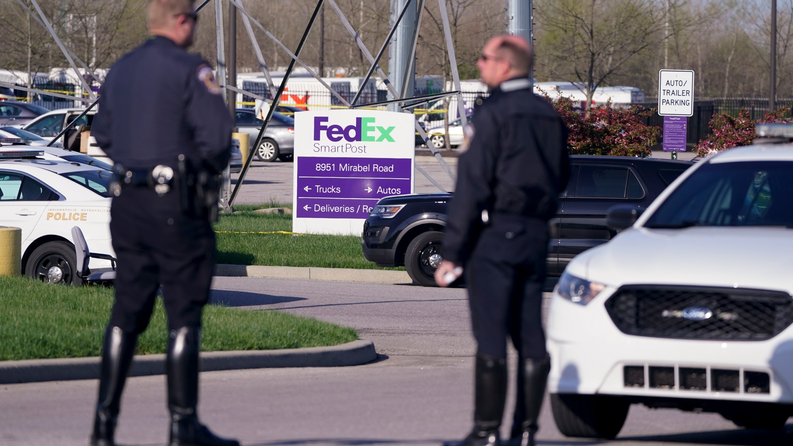 Police stand near the scene where multiple people were shot at the FedEx Ground facility early Friday morning, April 16, 2021, in Indianapolis. (AP Photo/Michael Conroy)