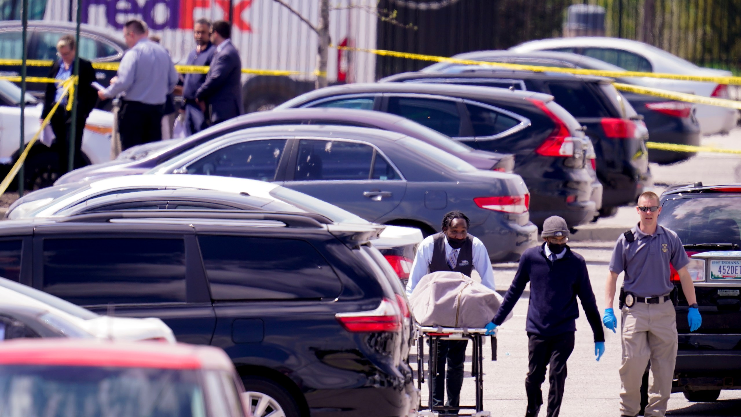 A body is taken from the scene where multiple people were shot at a FedEx Ground facility in Indianapolis, Friday, April 16, 2021. (AP Photo/Michael Conroy)