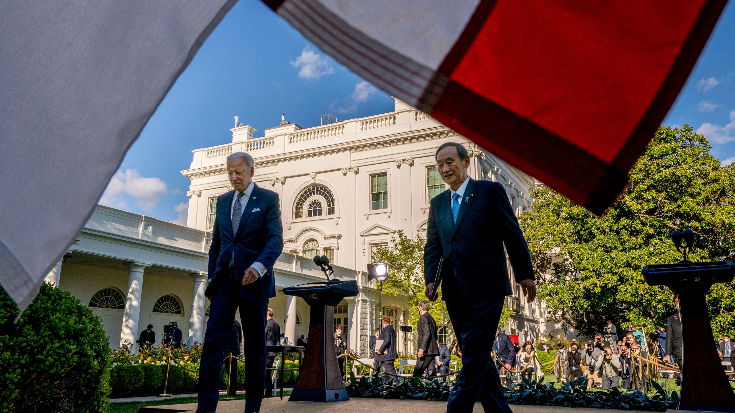 President Joe Biden and Japanese Prime Minister Yoshihide Suga leave a news conference in the Rose Garden of the White House in Washington, Friday, April 16, 2021. (AP Photo/Andrew Harnik)