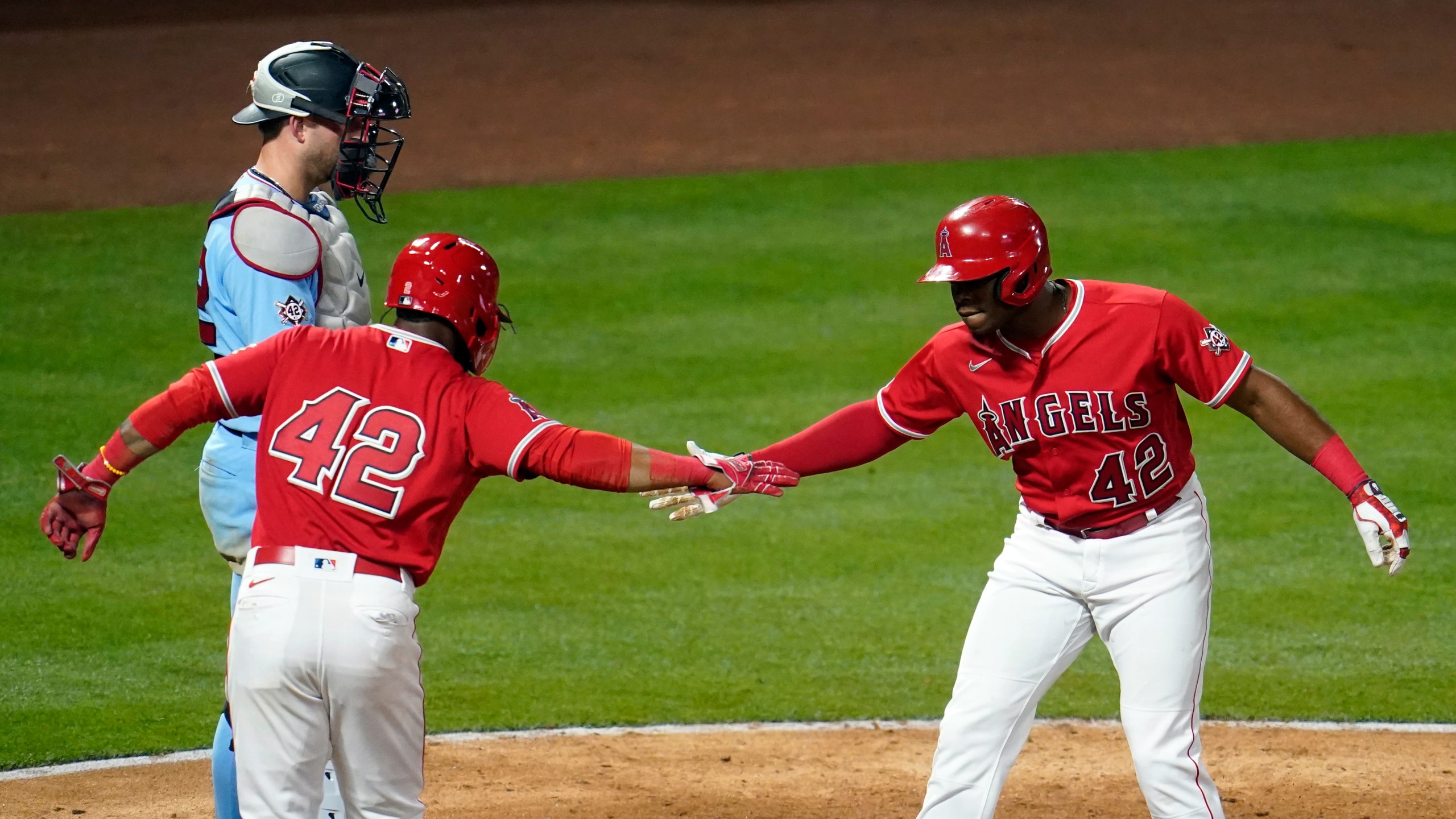 Los Angeles Angels' Justin Upton, right, celebrates his grand slam at home plate with Luis Rengifo during the seventh inning of a baseball game against the Minnesota Twins in Anaheim on April 16, 2021. (Marcio Jose Sanchez / Associated Press)