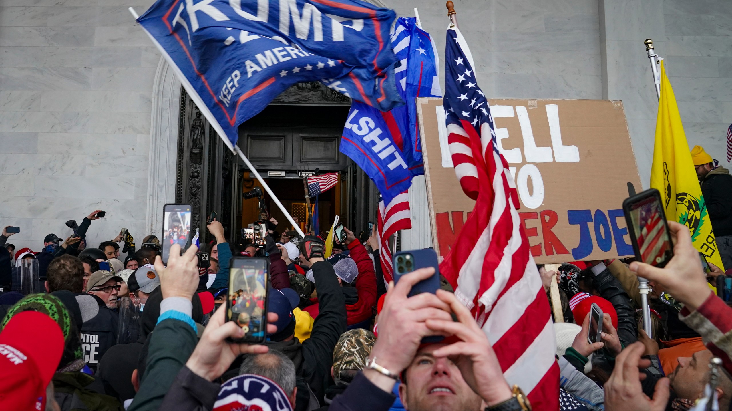 In this Jan. 6, 2021, file photo, Trump supporters gather outside the Capitol in Washington. Some people charged with storming the U.S. Capitol on Jan. 6 are claiming they were only there to record history as journalists, not join a deadly insurrection. Experts say it's unlikely that they can mount a viable defense on First Amendment free speech grounds, but some appear intent on trying. (AP Photo/John Minchillo, File)