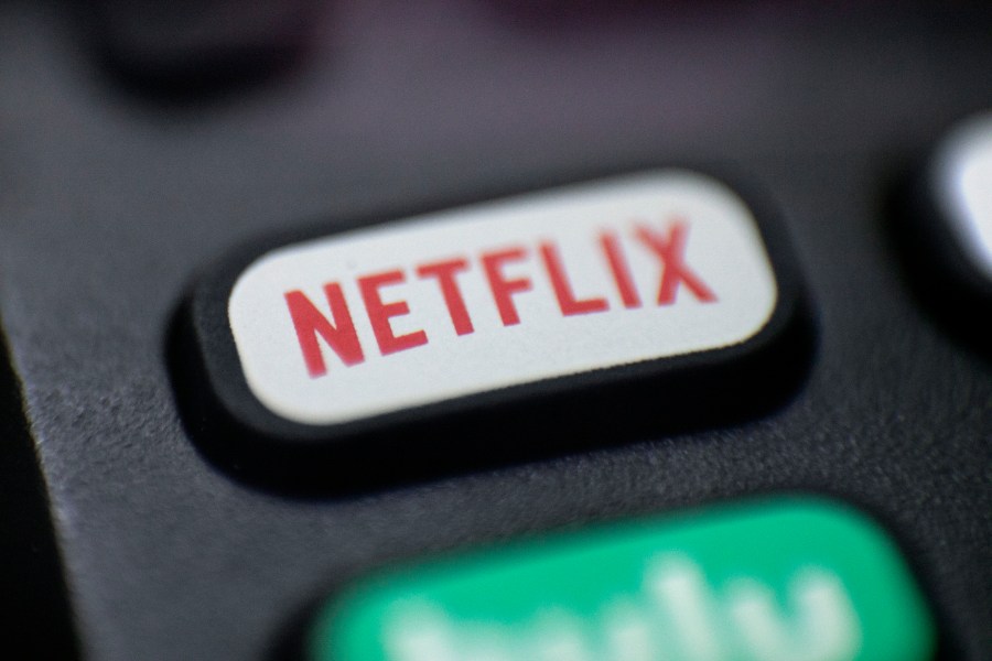 This Aug. 13, 2020 photo shows a logo for Netflix on a remote control in Portland, Ore. Netflix’s rapid subscriber growth is slowing far faster than anticipated, Tuesday, April 20, 2021, as people who have been cooped at home during the pandemic are able to get out and do other things again. The video streaming service added 4 million more worldwide subscribers from January through March, its smallest gain during that three-month period in four years. (AP Photo/Jenny Kane, File)