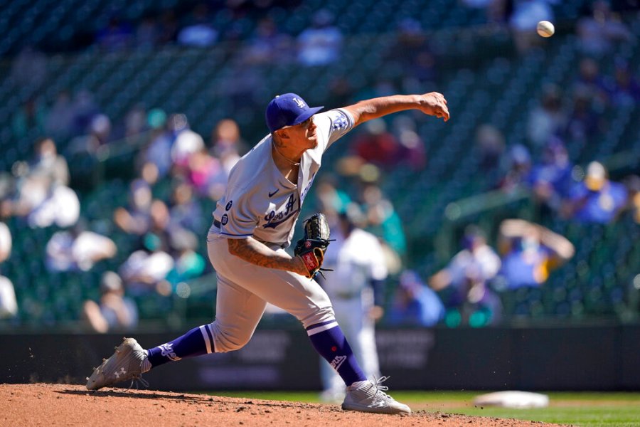 Los Angeles Dodgers starting pitcher Julio Urias throws against the Seattle Mariners in the fourth inning of a baseball game Tuesday, April 20, 2021, in Seattle. (AP Photo/Ted S. Warren)