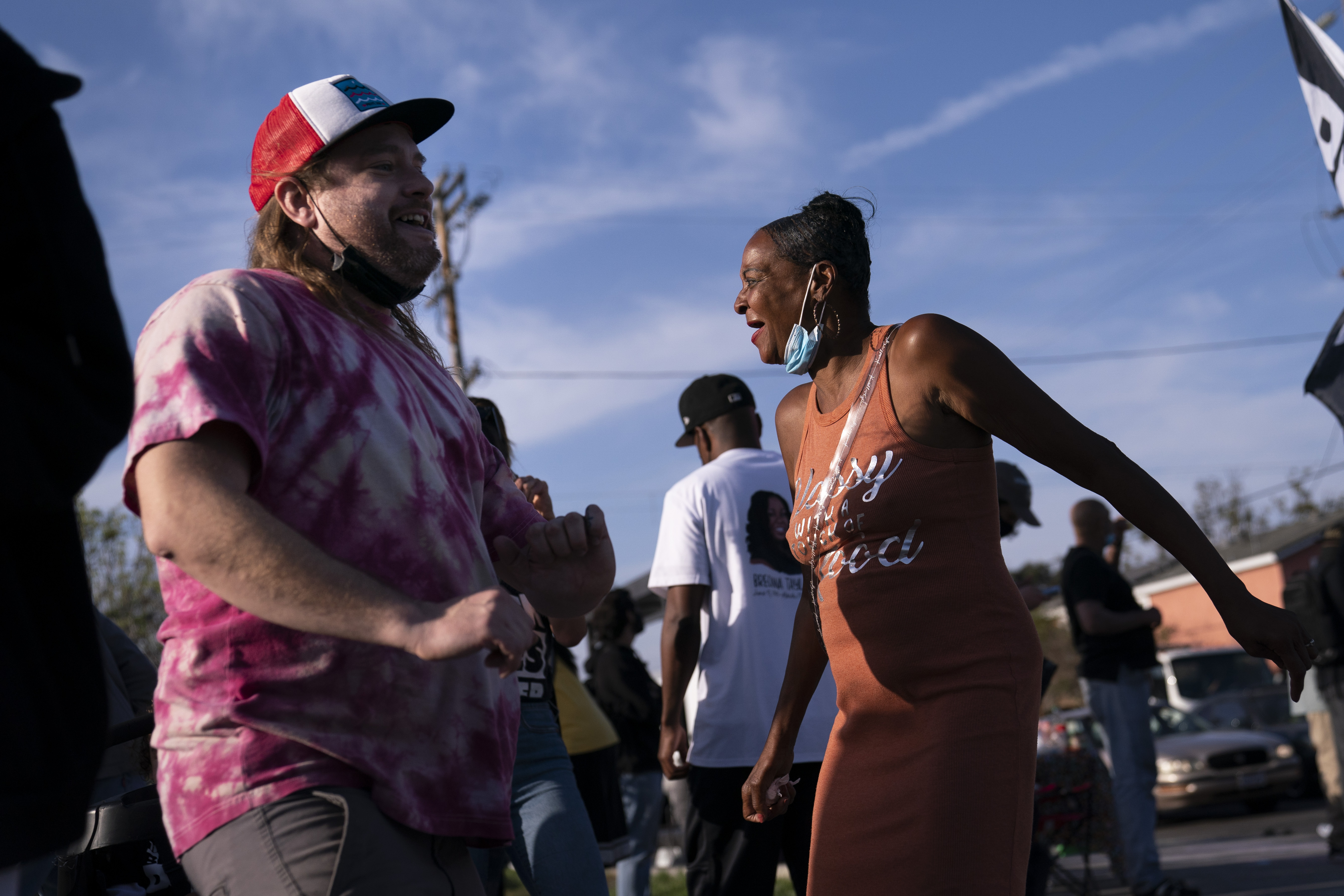 Sherri Burks, right, and Dominic Fawcett dance at the intersection of Florence and Normandie Avenues, on April 20, 2021, in Los Angeles, after a guilty verdict was announced at the trial of former Minneapolis police Officer Derek Chauvin for the 2020 death of George Floyd. (AP Photo/Jae C. Hong)