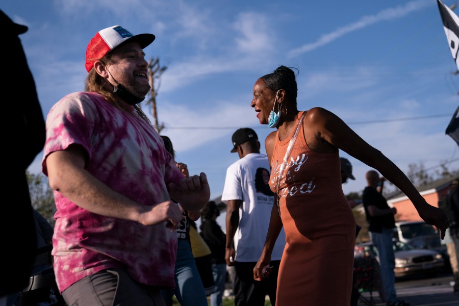 Sherri Burks, right, and Dominic Fawcett dance at the intersection of Florence and Normandie Avenues, on April 20, 2021, in Los Angeles, after a guilty verdict was announced at the trial of former Minneapolis police Officer Derek Chauvin for the 2020 death of George Floyd. (AP Photo/Jae C. Hong)