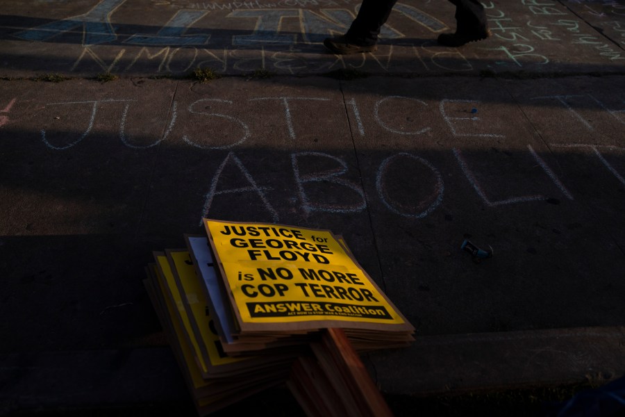 Protest signs are stacked on a sidewalk near the intersection of Florence and Normandie Avenues in Los Angeles, on April 20, 2021, after a guilty verdict was announced at the trial of former Minneapolis police Officer Derek Chauvin for the 2020 death of George Floyd. (AP Photo/Jae C. Hong)