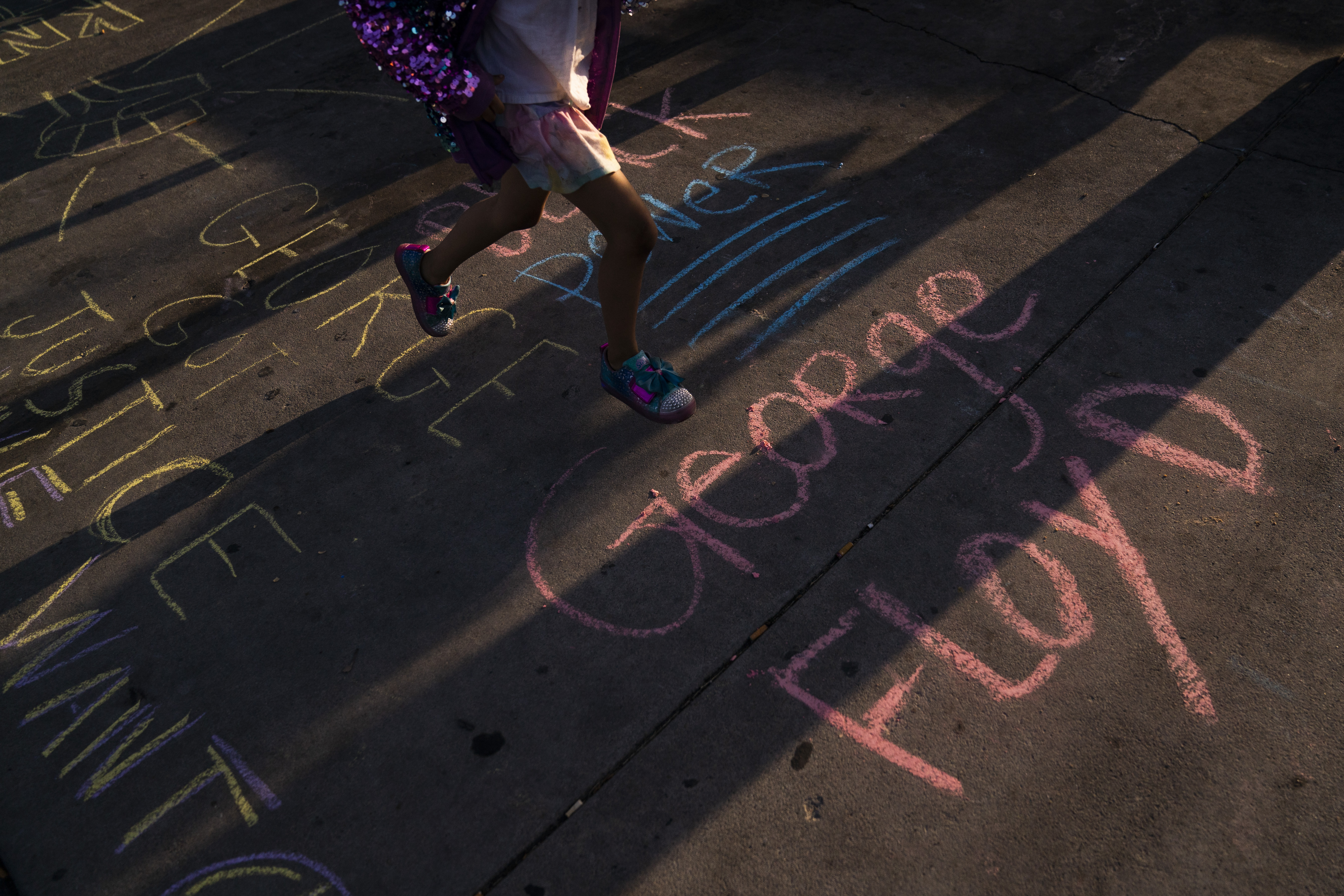 George Floyd's name is written on a sidewalk near the intersection of Florence and Normandie Avenues in Los Angeles, on April 20, 2021, after a guilty verdict was announced at the trial of former Minneapolis police Officer Derek Chauvin for the 2020 death of George Floyd. (AP Photo/Jae C. Hong)