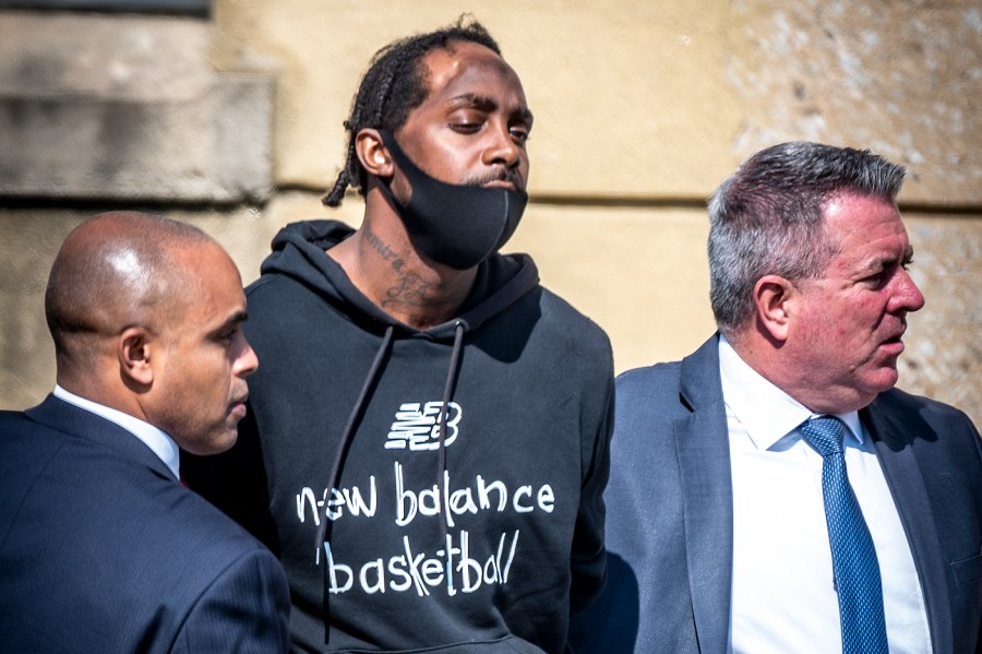 Nassau County police take into custody Gabriel DeWitt Wilson, center, the suspect in a fatal shooting at a grocery store in West Hempstead, Long Island, on April 20, 2021. (J. Conrad Williams Jr. / Newsday via Associated Press)