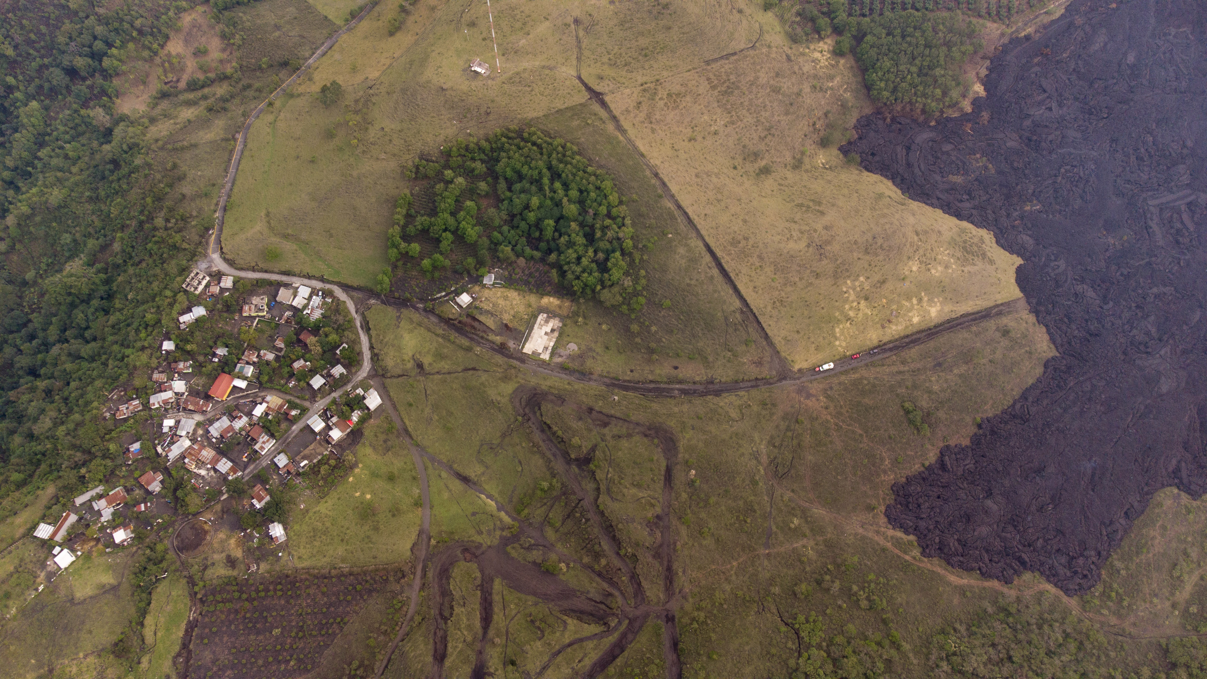 Lava flows down the slopes of the Pacaya Volcano near El Patrocinio village in San Vicente Pacaya, Guatemala on April 21, 2021. (Moises Castillo/Associated Press)