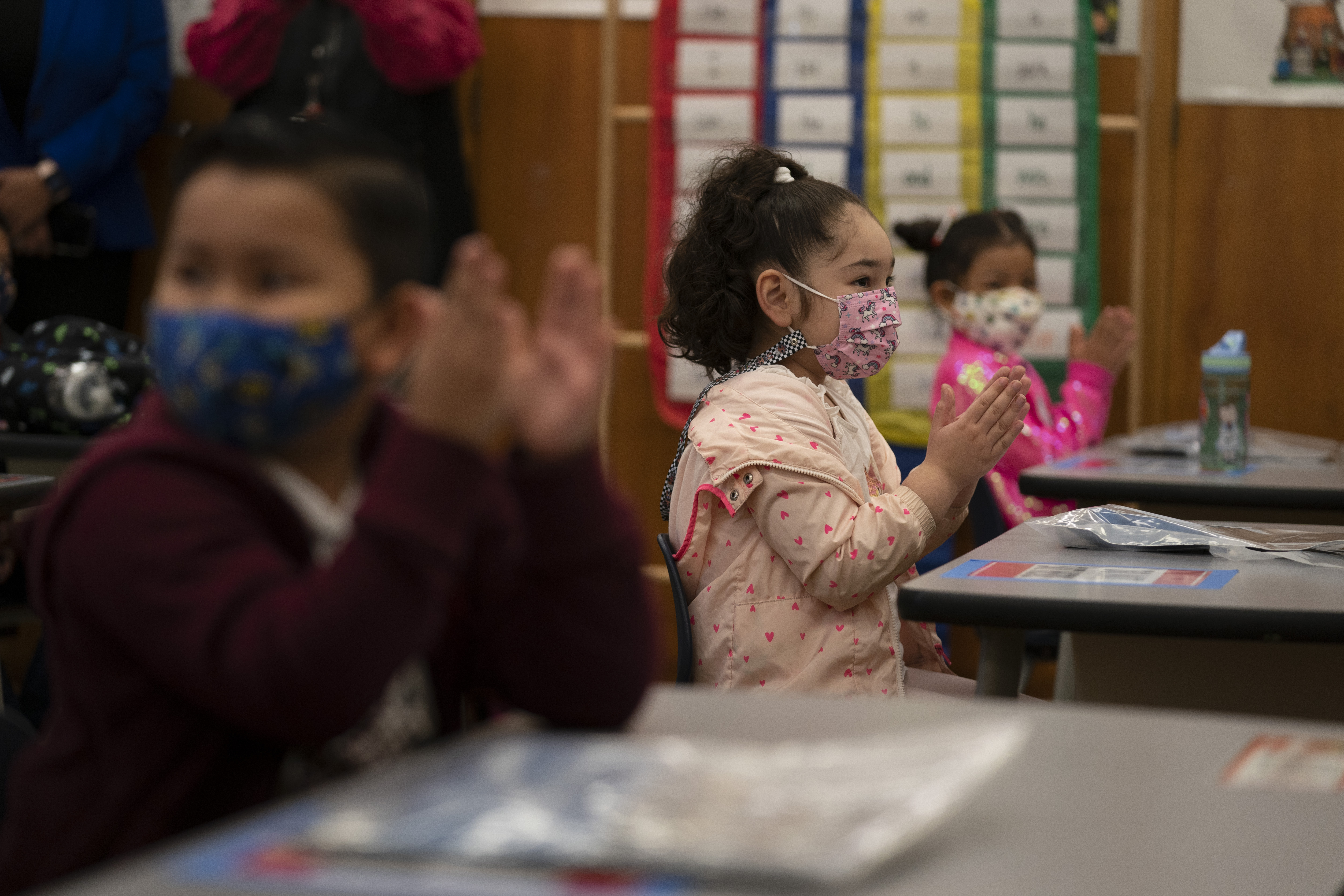 First graders applaud while listening to their teacher in a classroom on the first day of in-person learning at Heliotrope Avenue Elementary School in Maywood on April 13, 2021. (Jae C. Hong / Associated Press)