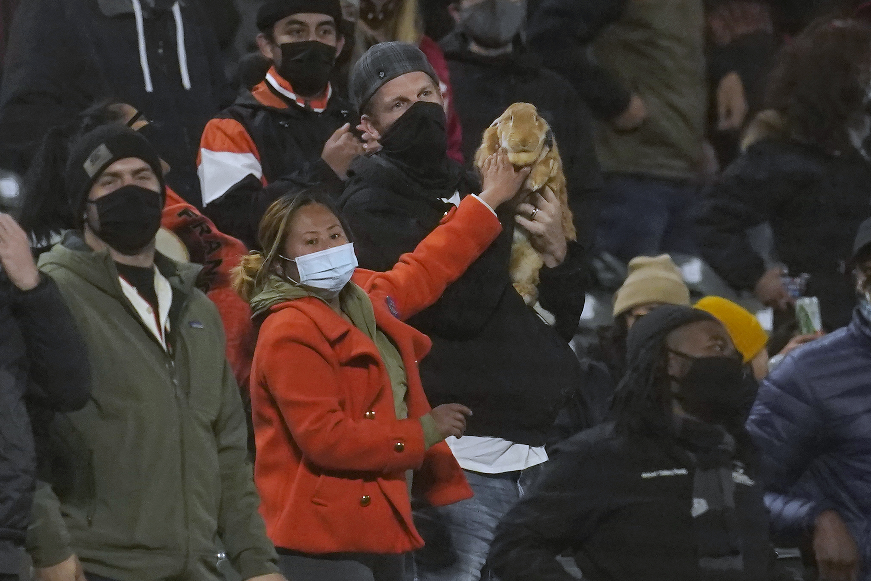 Kei Kato, left, and her fiance, Josh Row, hold a therapy rabbit named Alex during the ninth inning of a baseball game between the San Francisco Giants and the Miami Marlins in San Francisco, Thursday, April 22, 2021. (AP Photo/Jeff Chiu)