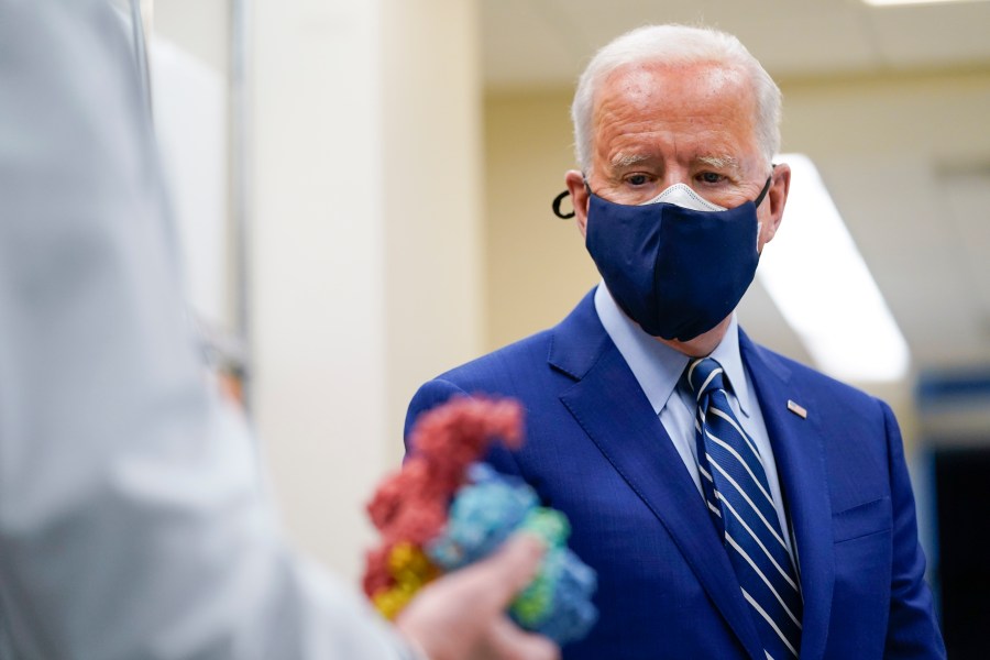 In this Feb. 11, 2021, file photo President Joe Biden looks at a model of Covid-19 as he visits the Viral Pathogenesis Laboratory at the National Institutes of Health in Bethesda, Md. (AP Photo/Evan Vucci, File)