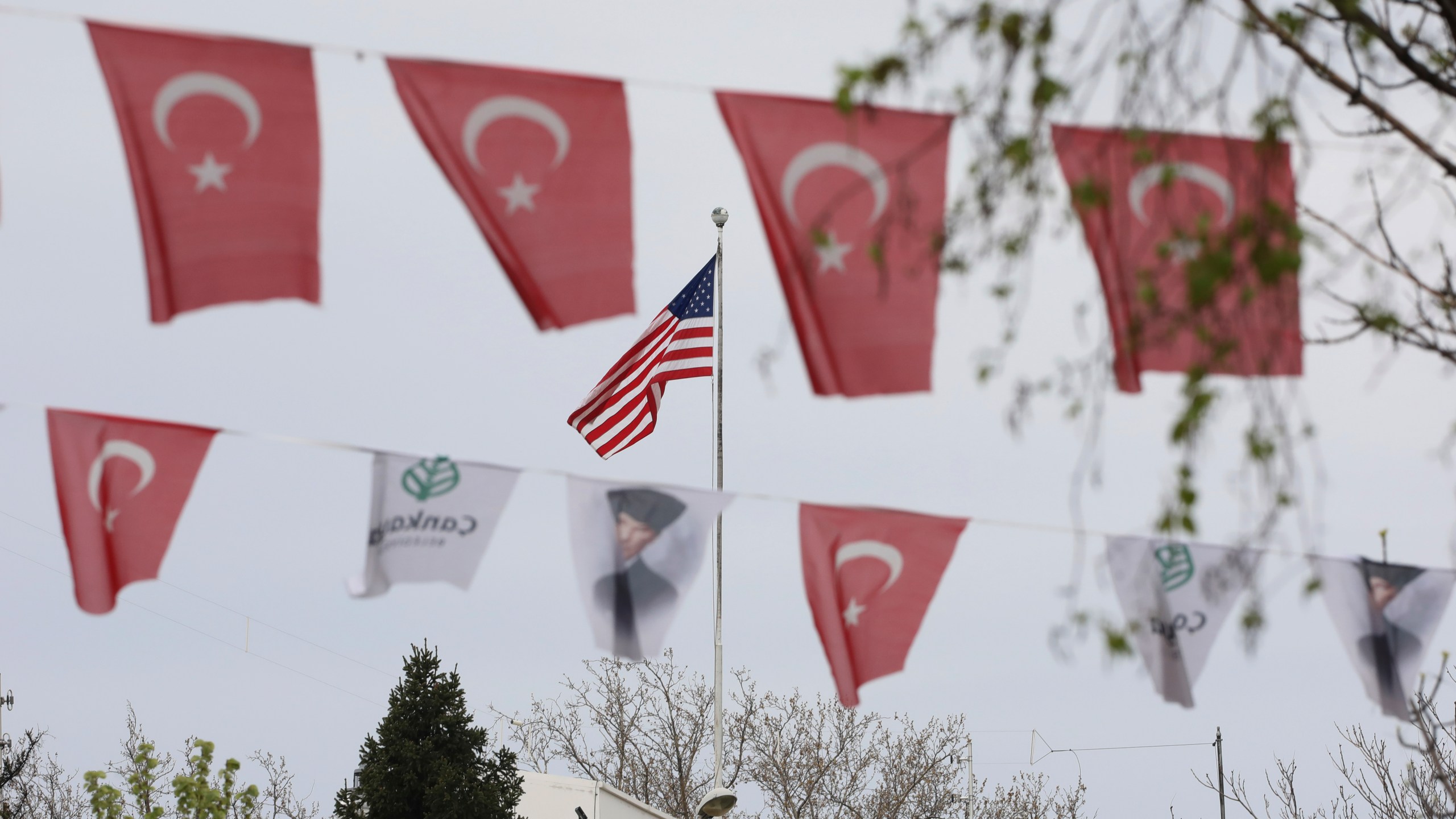 Turkish flags and banners depicting Mustafa Kemal Ataturk, the founder of modern Turkey, decorate a street outside the United States embassy in Ankara, Turkey on April 25, 2021. (AP Photo/Burhan Ozbilici)