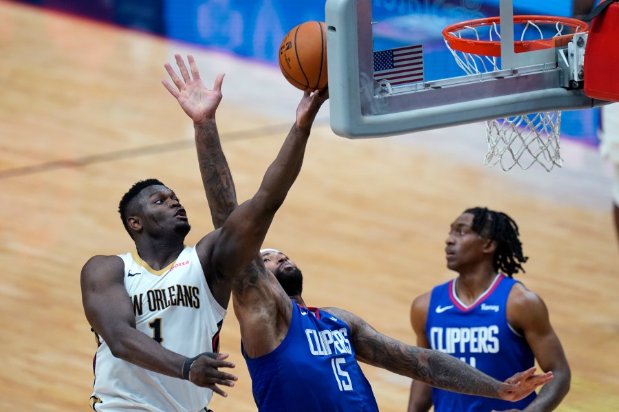 New Orleans Pelicans forward Zion Williamson (1) goes to the basket against LA Clippers center DeMarcus Cousins (15) in the second half of an NBA basketball game in New Orleans on April 26, 2021. (Gerald Herbert / Associated Press)