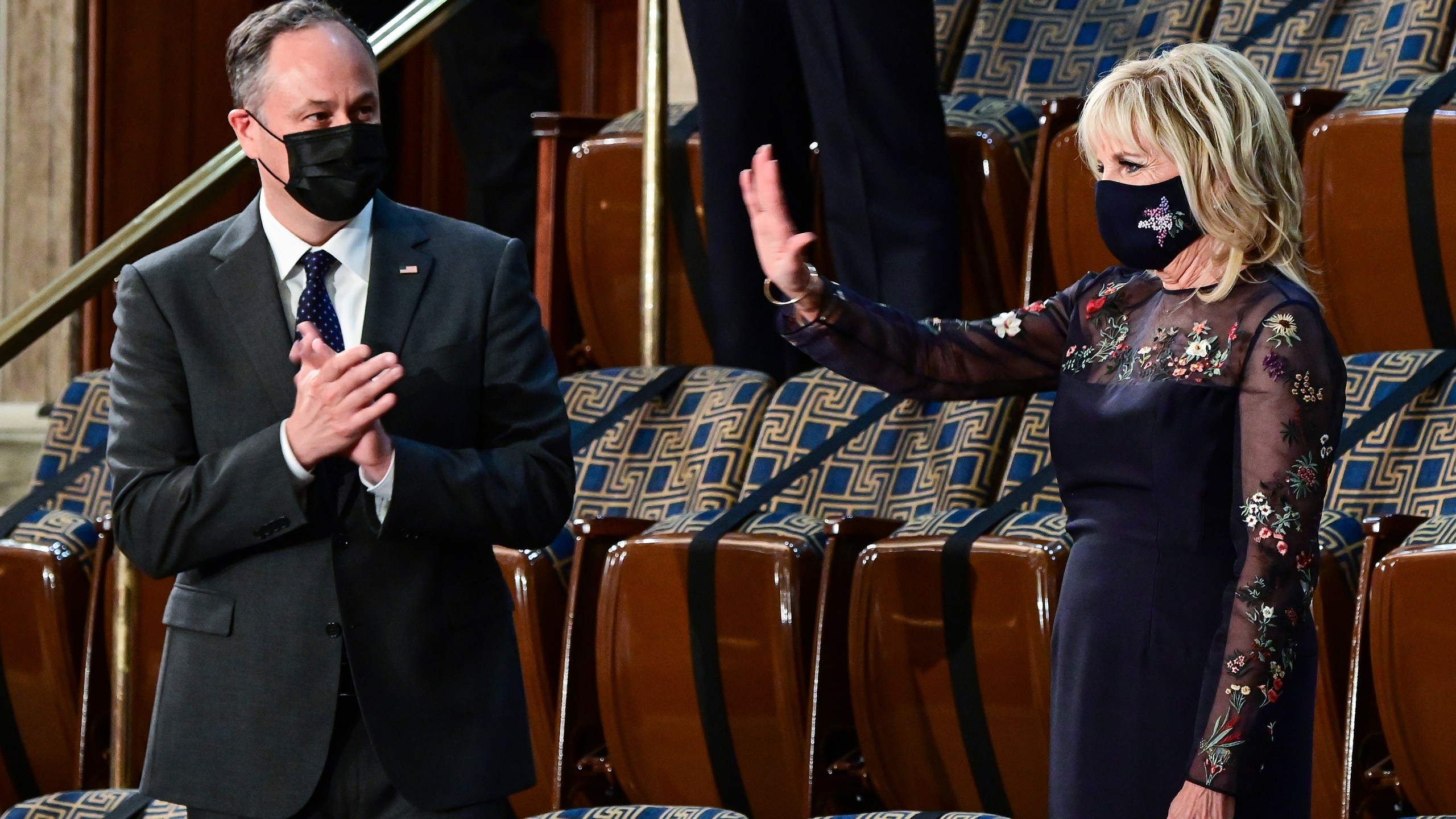 First lady Jill Biden waves as she arrives prior to President Joe Biden arriving to address a joint session of Congress, Wednesday, April 28, 2021, in the House Chamber at the U.S. Capitol in Washington, as Doug Emhoff looks on. (Jim Watson/Pool via AP)