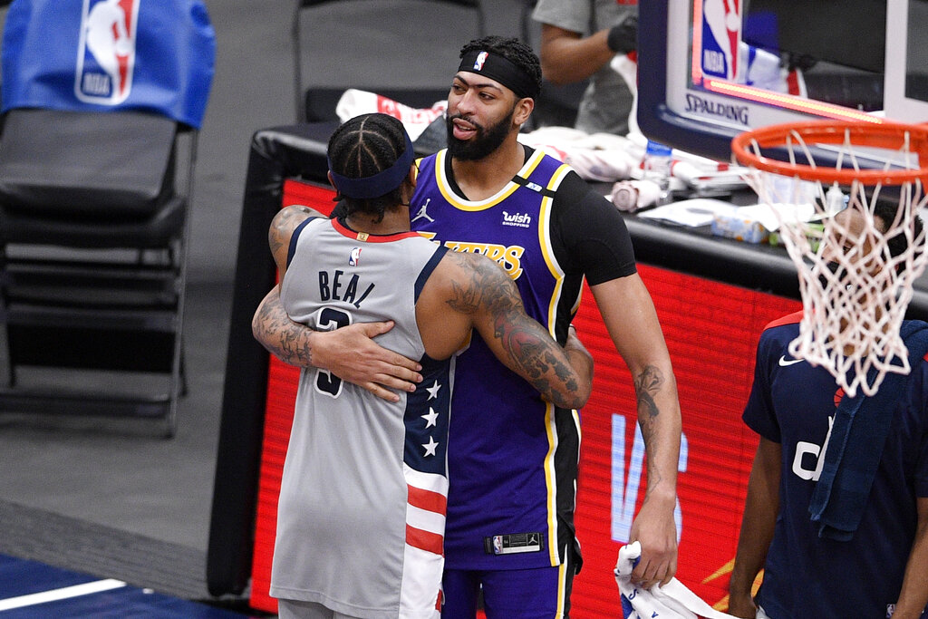 Washington Wizards guard Bradley Beal, left, and Los Angeles Lakers forward Anthony Davis, right, hug after an NBA basketball game, Wednesday, April 28, 2021, in Washington. The Wizards won 116-107. (AP Photo/Nick Wass)