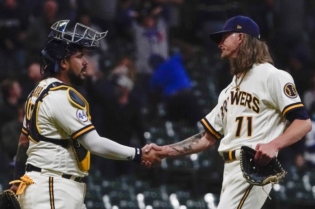 Milwaukee Brewers' Josh Hader is congratulated by catcher Omar Narvaez after picking up a save after a baseball game against the Los Angeles Dodgers Thursday, April 29, 2021, in Milwaukee. The Brewers won 2-1. (AP Photo/Morry Gash)