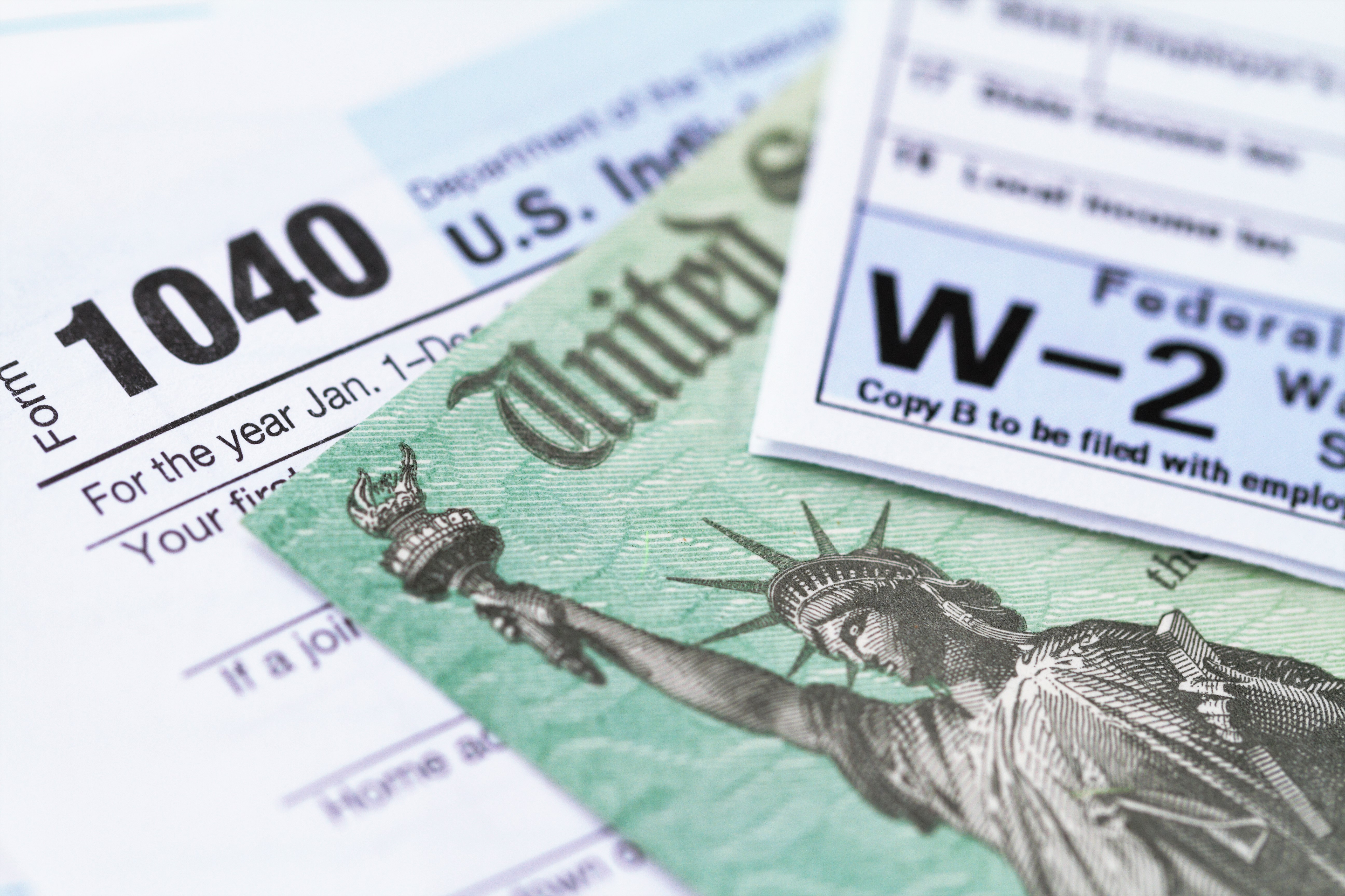 An IRS tax form with a tax refund check are seen in a file photo. (iStock/Getty Images Plus)